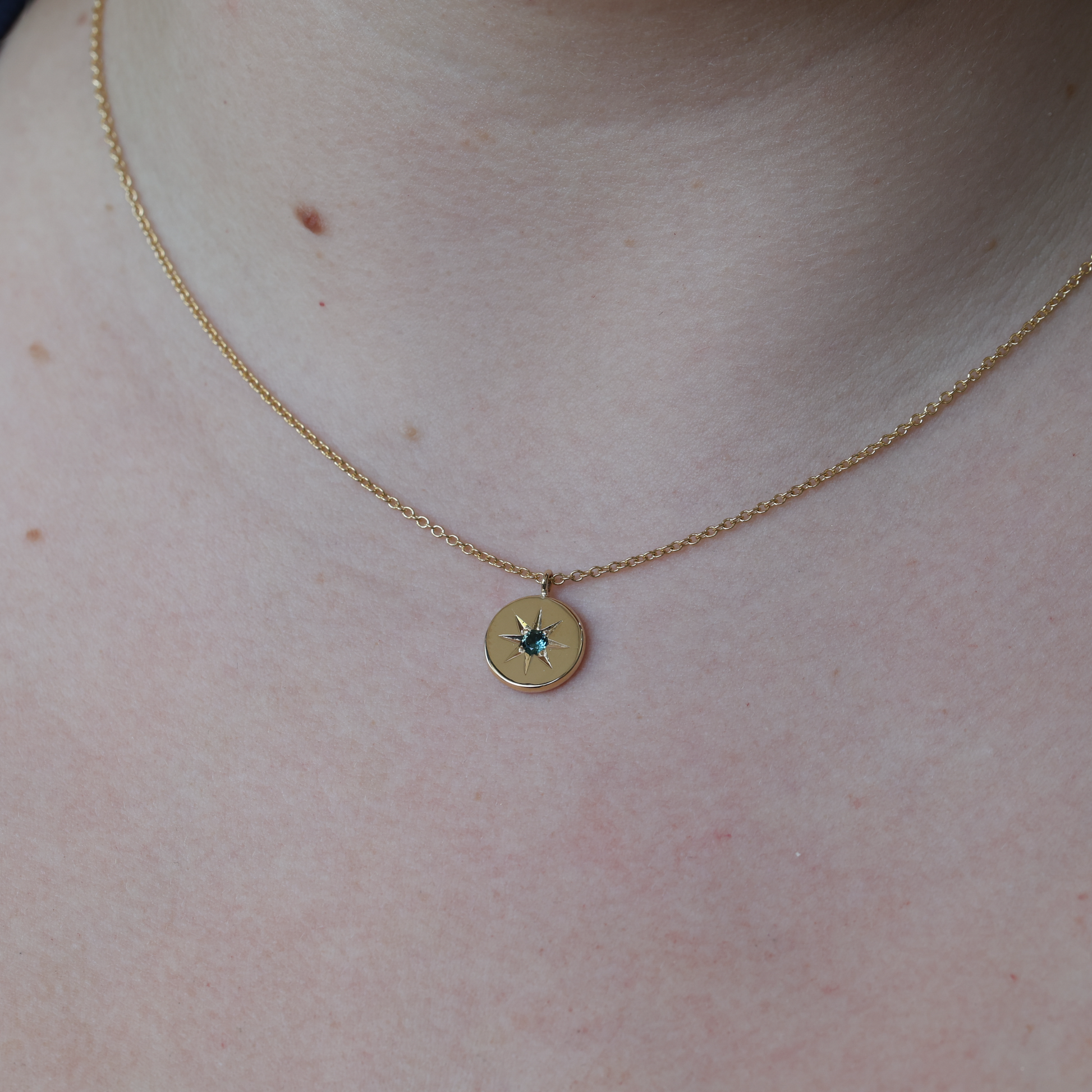 star set Sapphire medallion necklace on neck