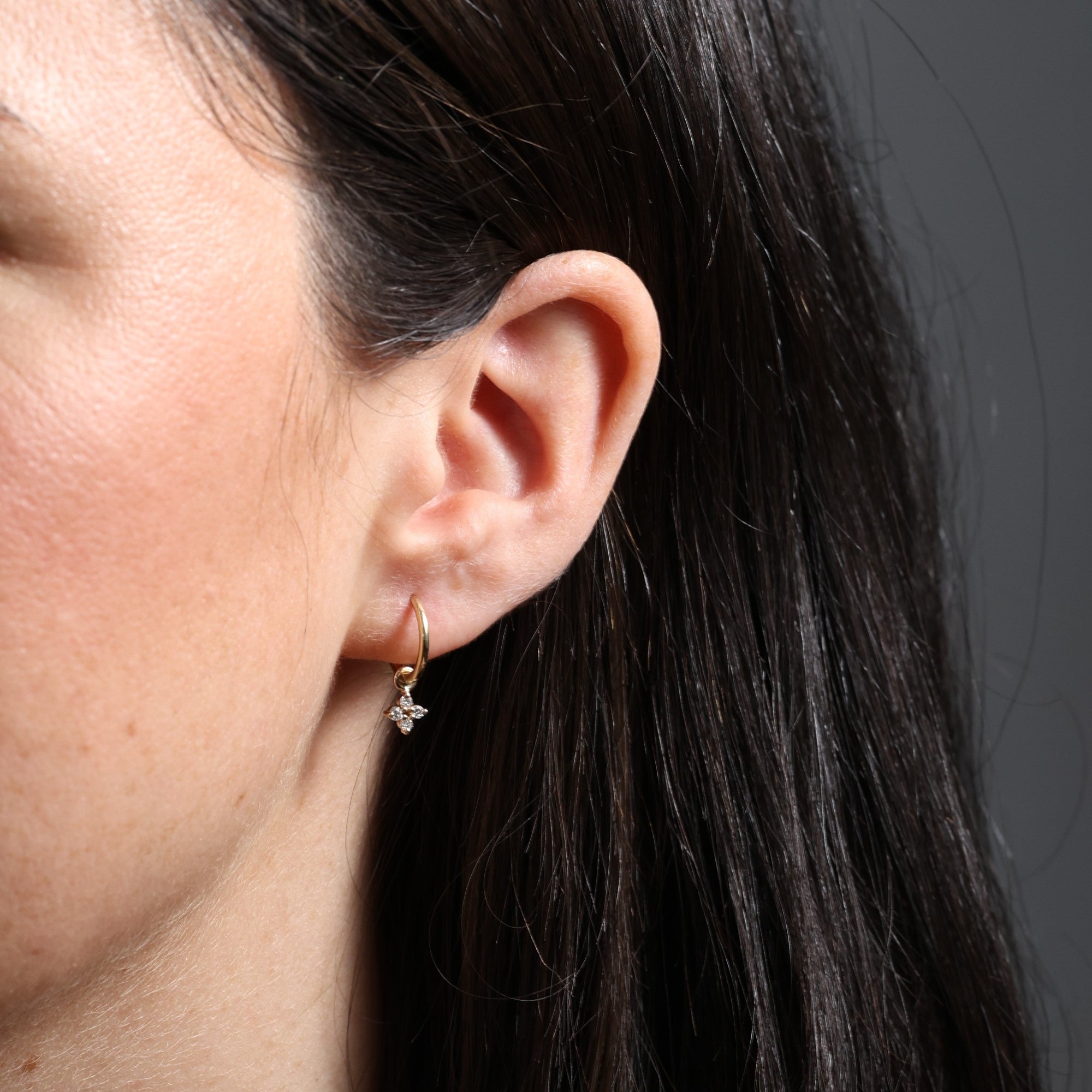 Starburst diamond hoop earrings in ear