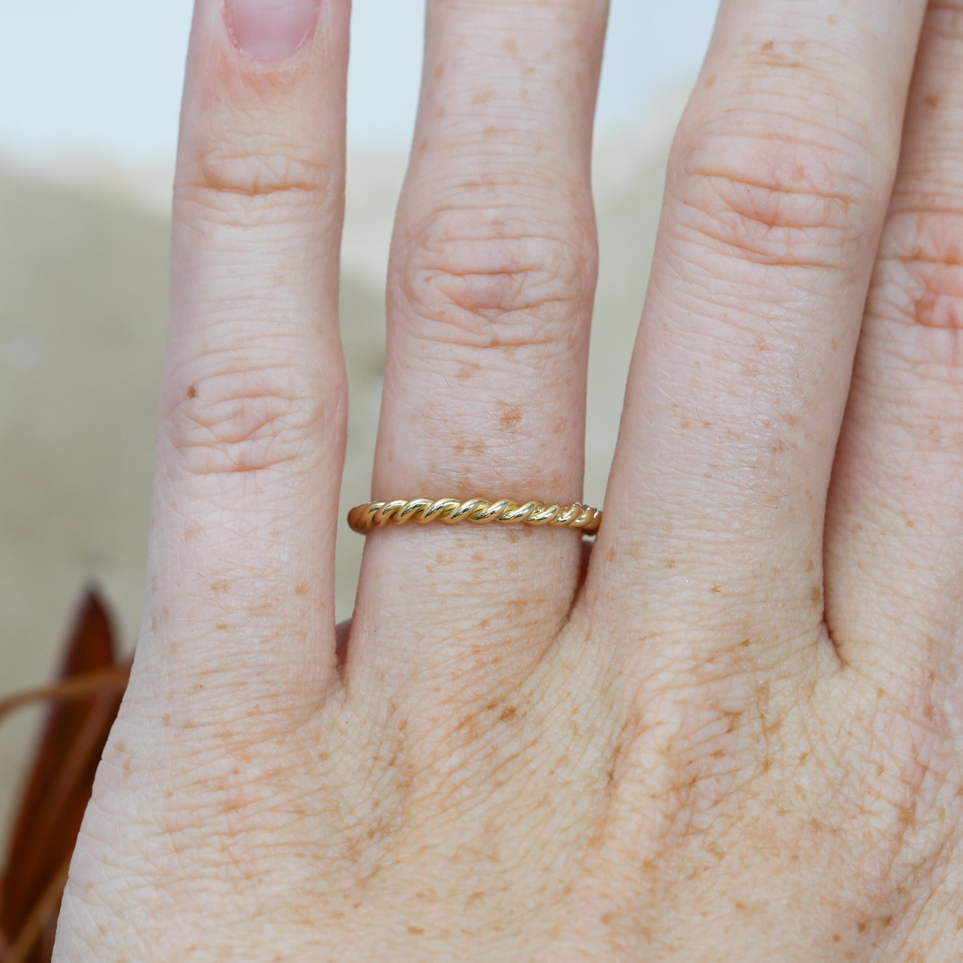 Tight twist wedding band on hand