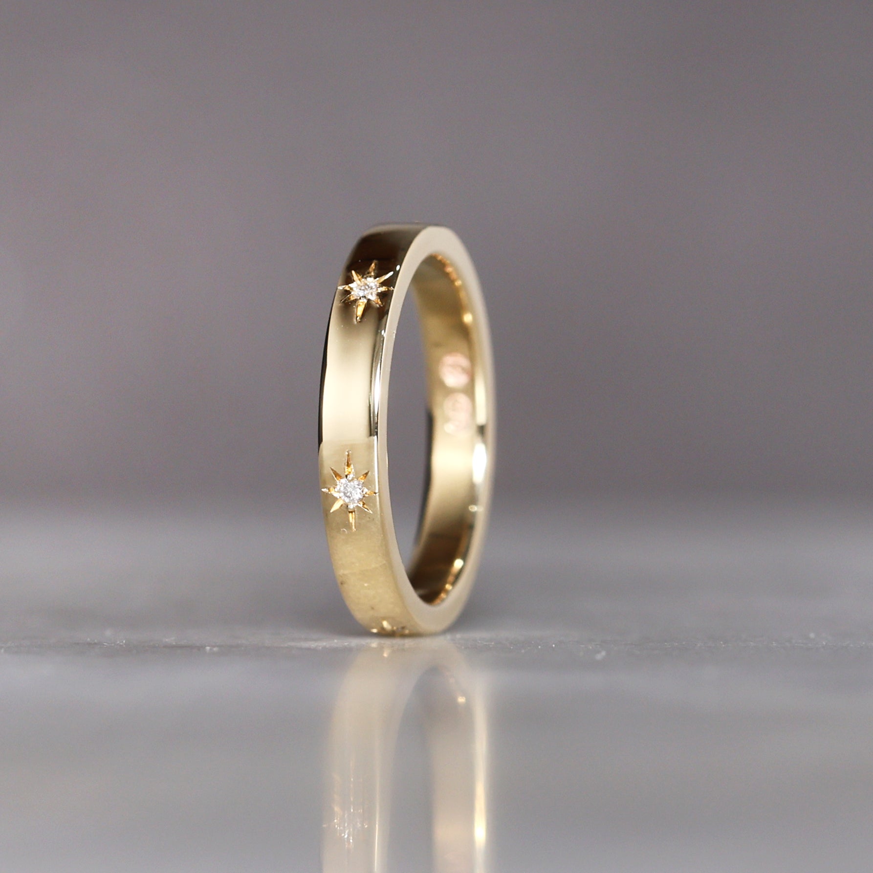 gold cigar wedding band with star set diamonds