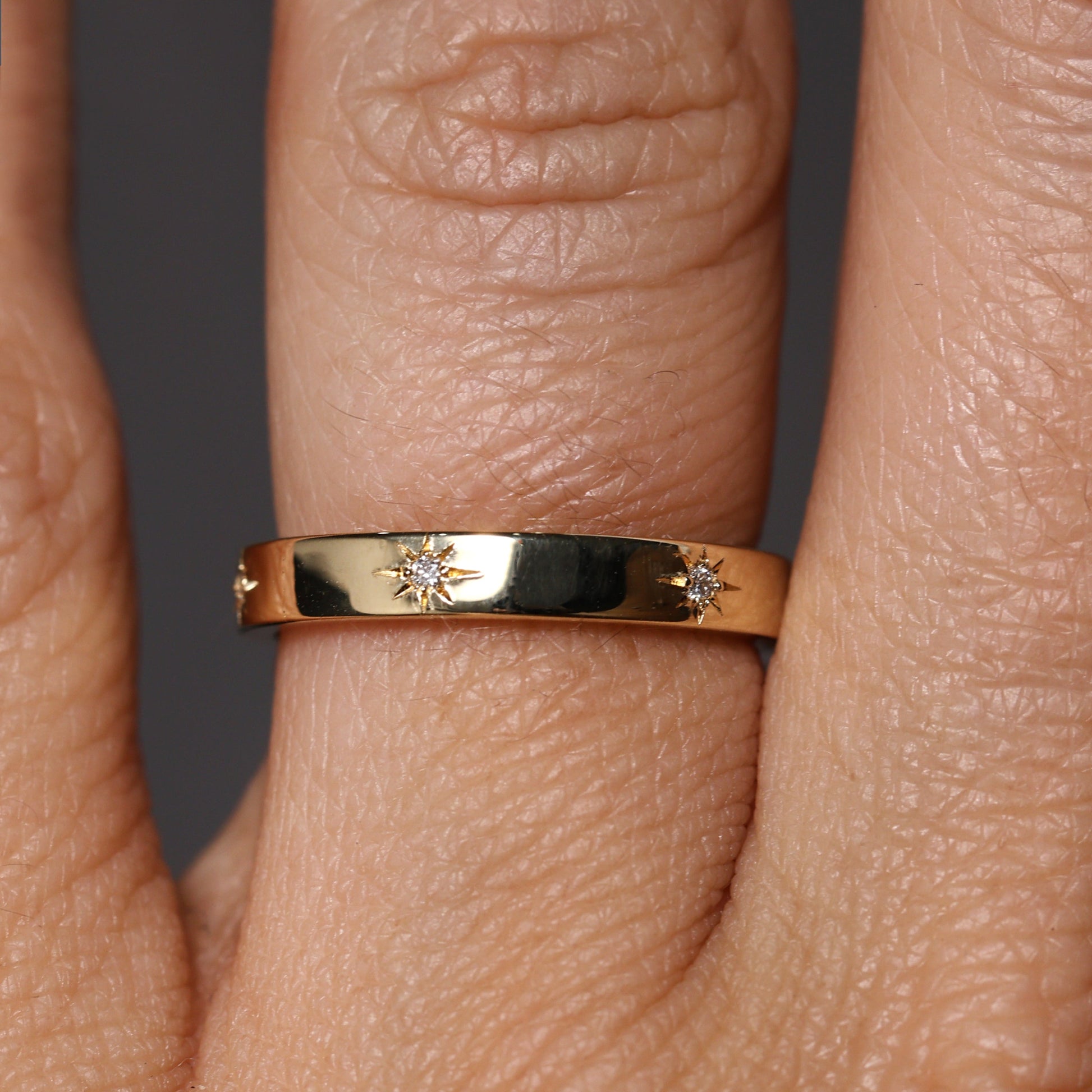 gold cigar wedding band with star set diamonds
