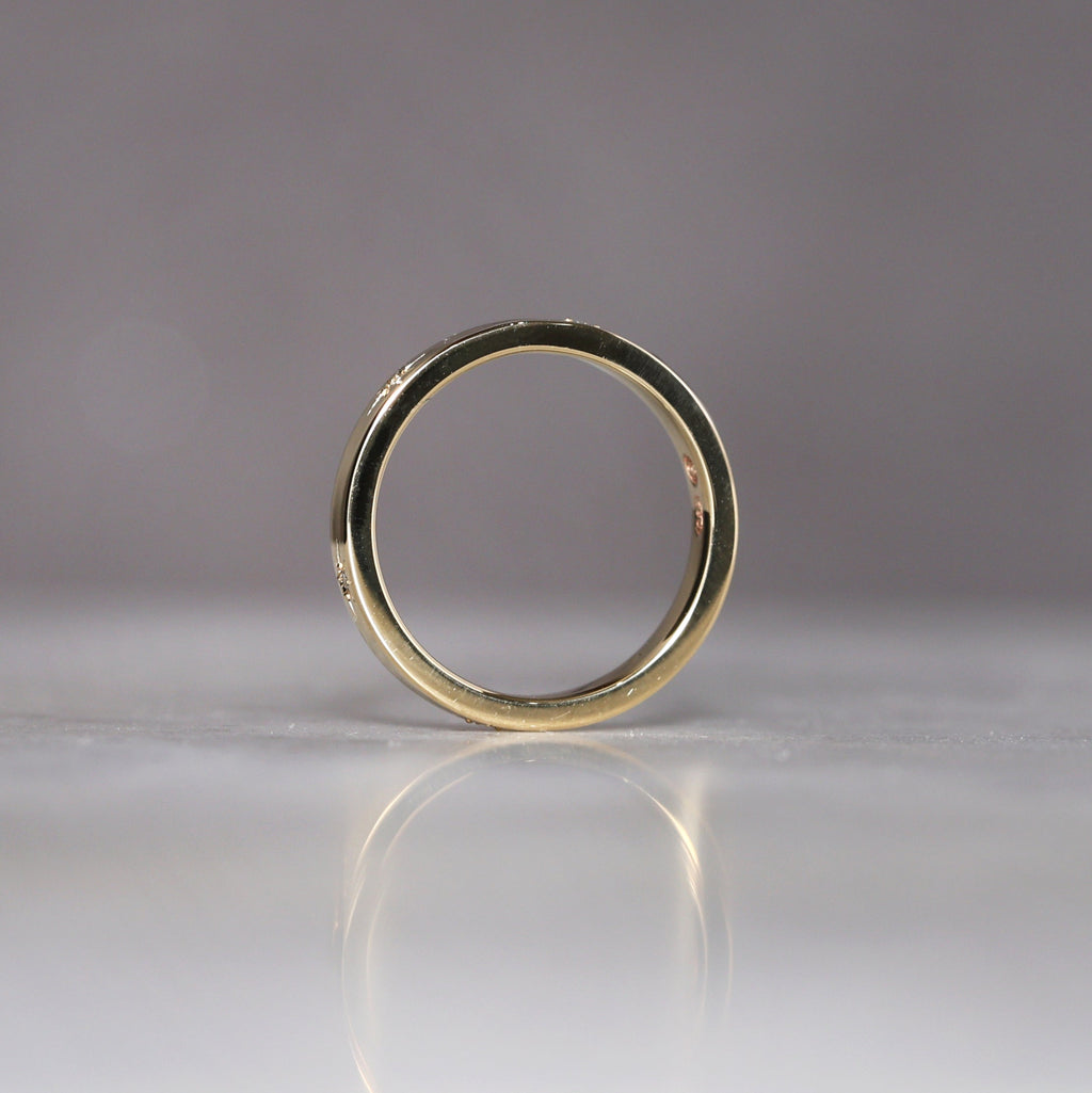 gold cigar wedding band with star set diamonds