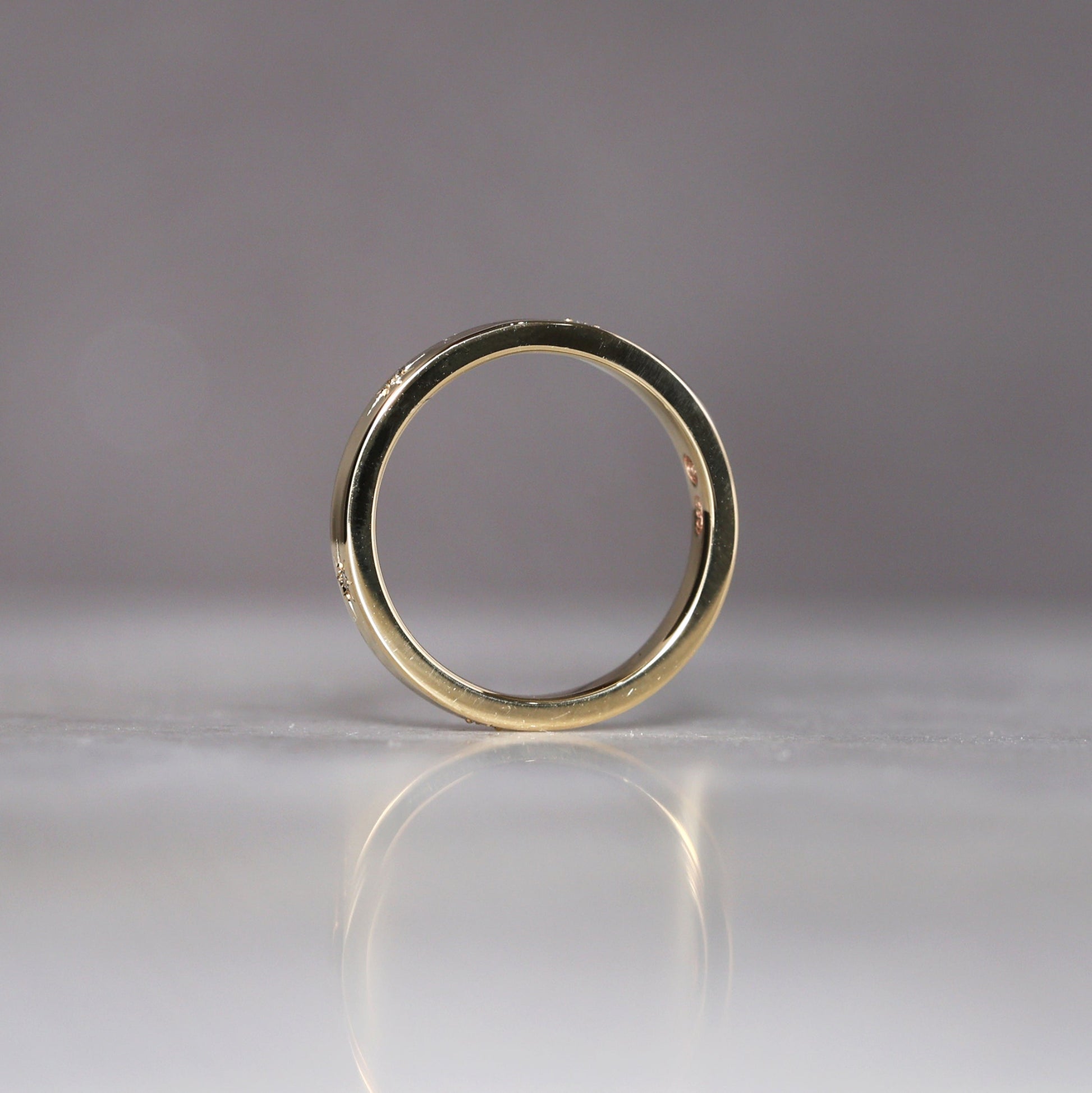 gold cigar wedding band with star set diamonds