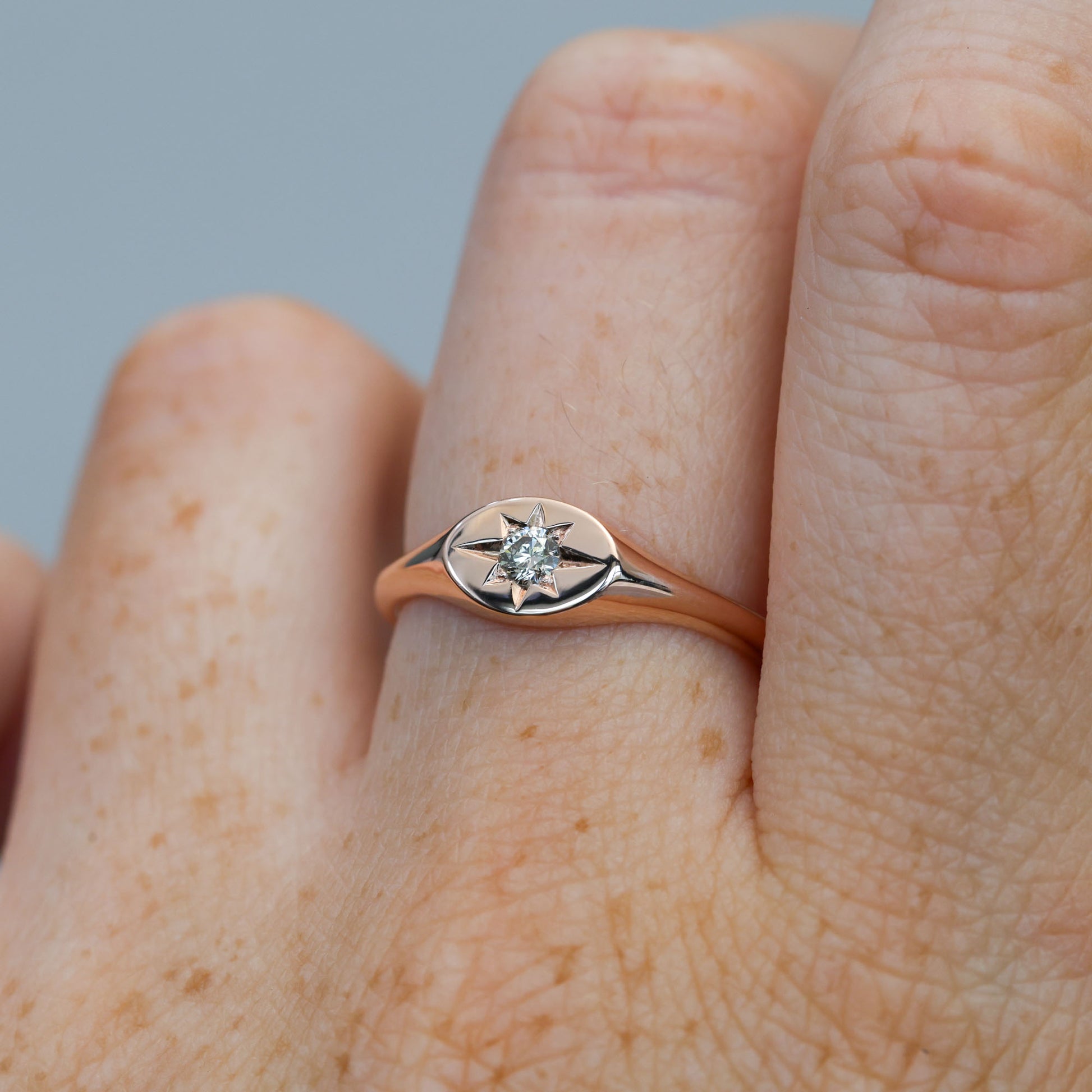 champagne diamond signet ring on hand