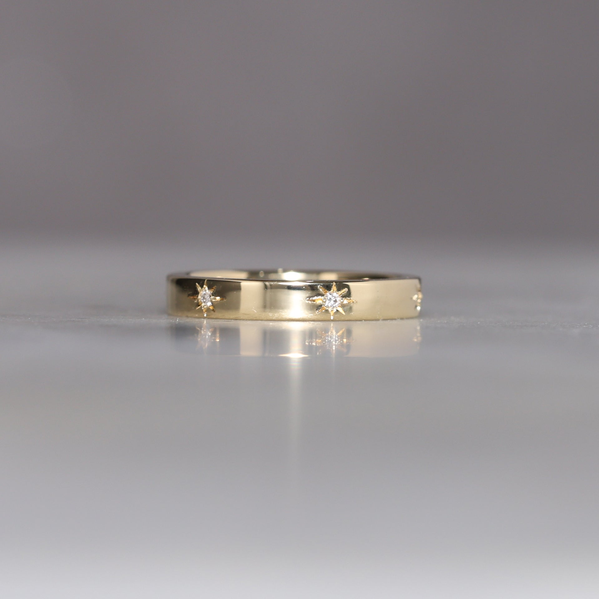 gold cigar wedding band with star set diamonds