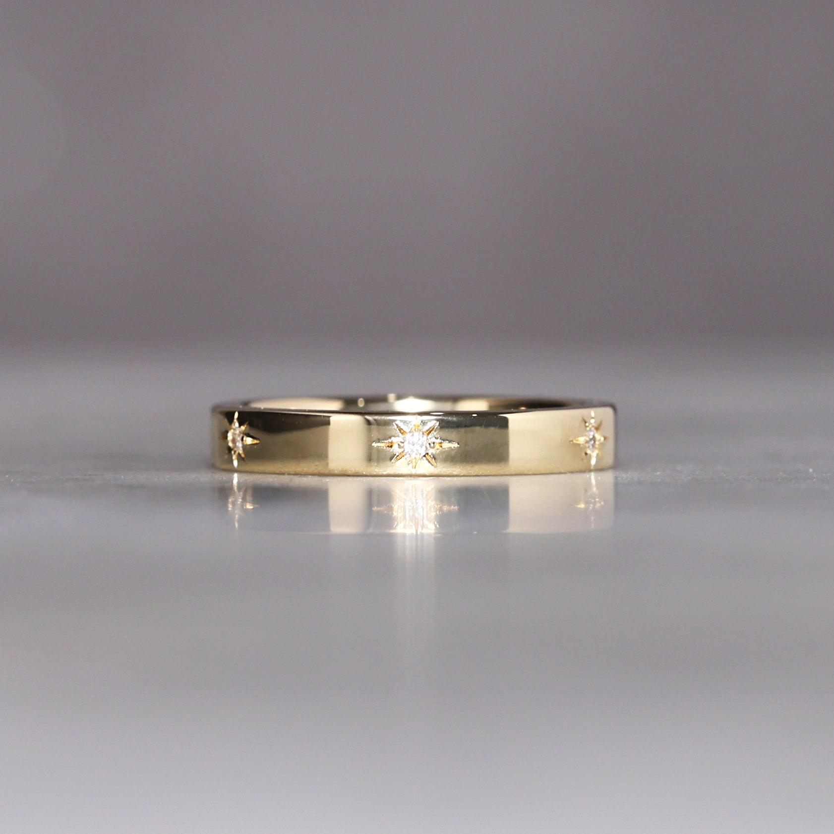 gold cigar wedding band with star set diamonds