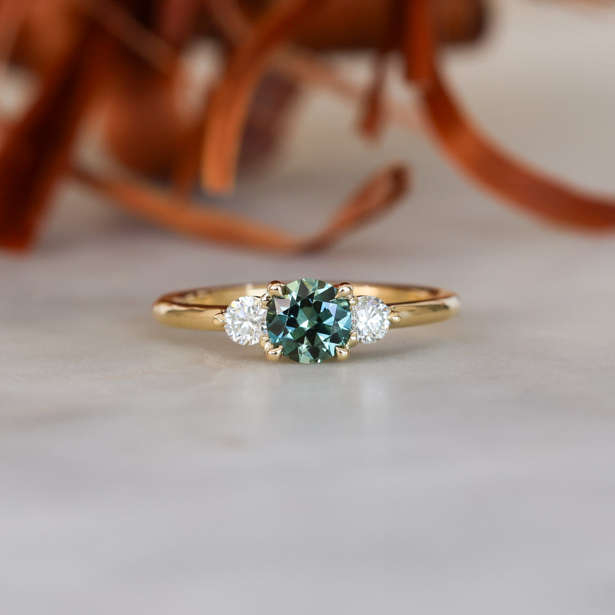 0.68ct round cut natural australian sapphire and diamond trilogy engagement ring in yellow gold