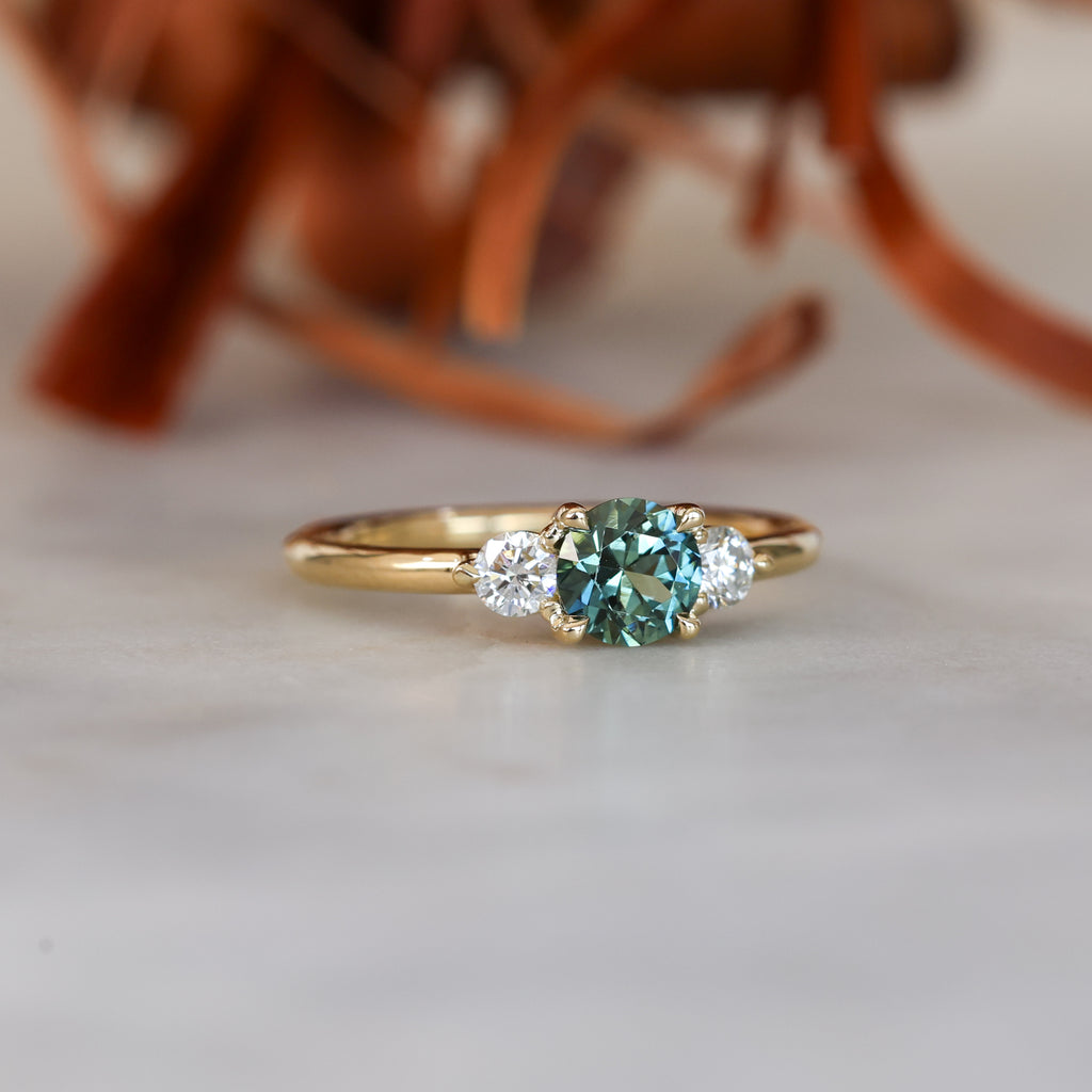 0.68ct round cut natural australian sapphire and diamond trilogy engagement ring in yellow gold