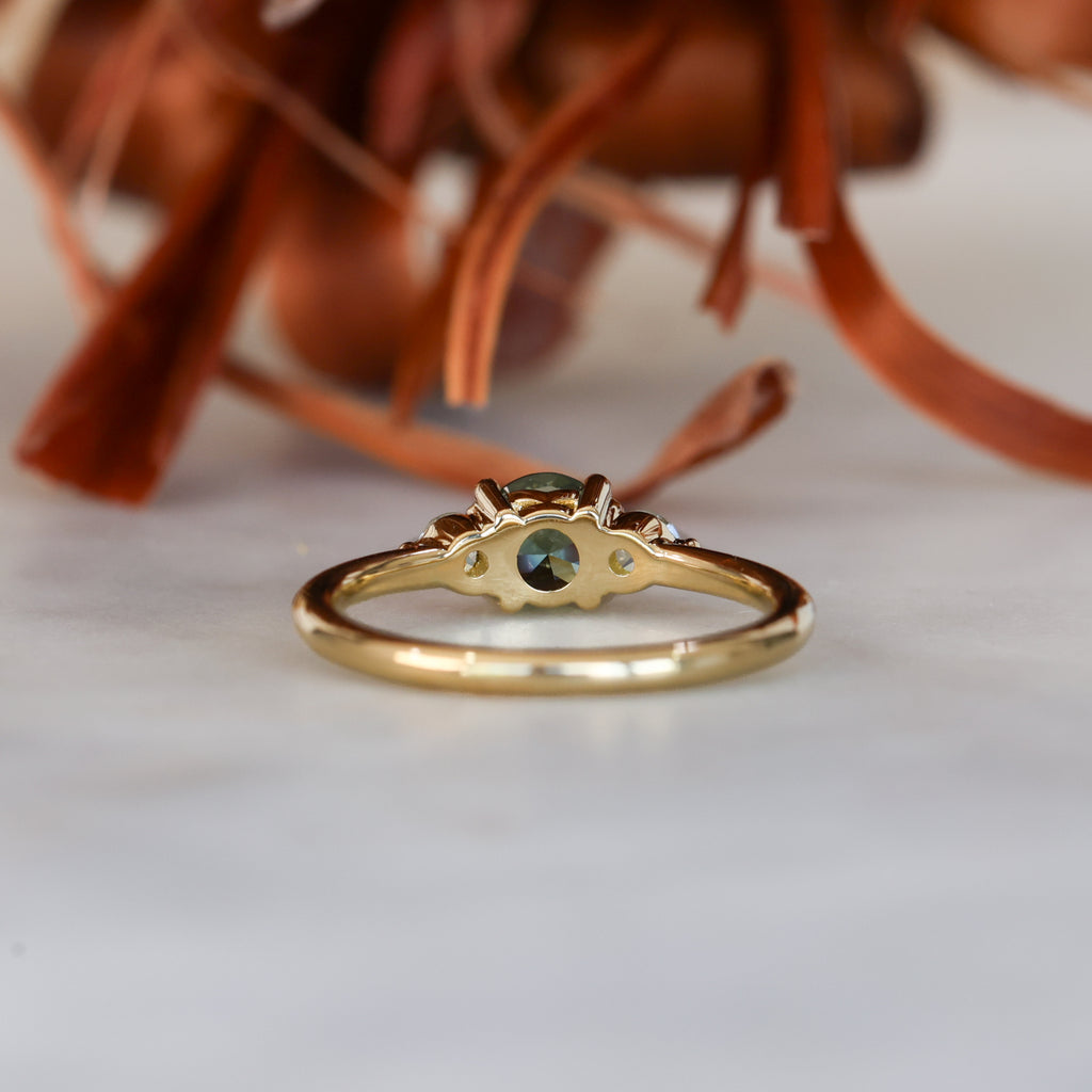 0.68ct round cut natural australian sapphire and diamond trilogy engagement ring in yellow gold