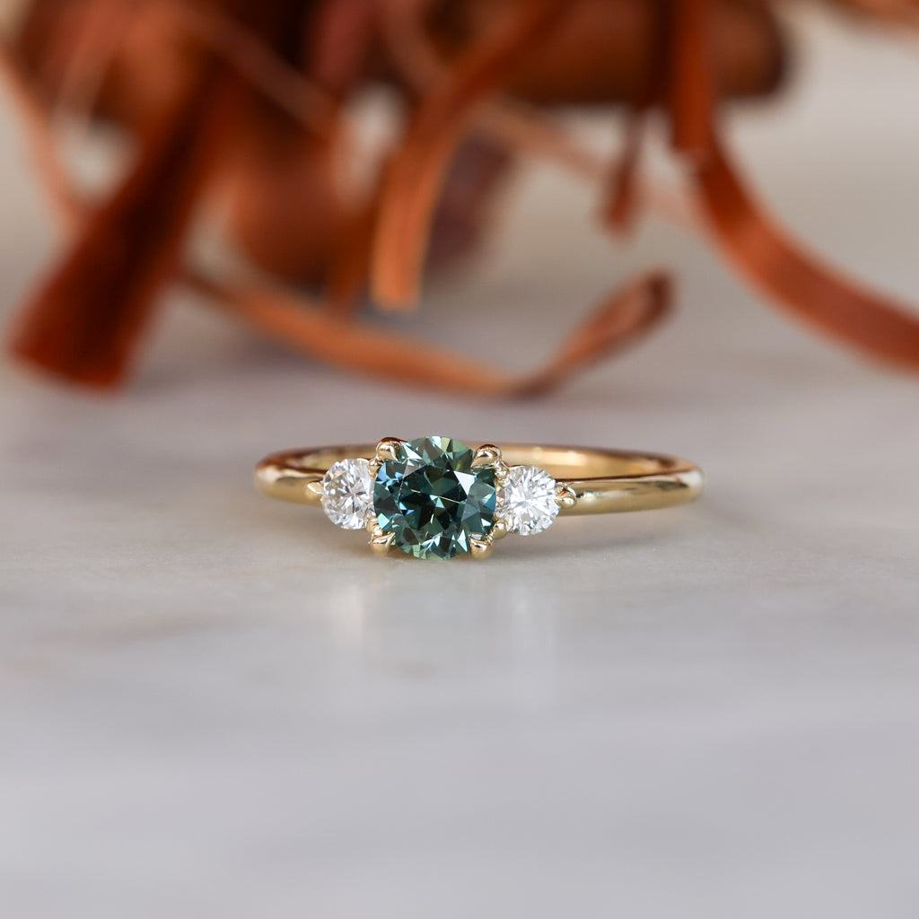 0.68ct round cut natural australian sapphire and diamond trilogy engagement ring in yellow gold