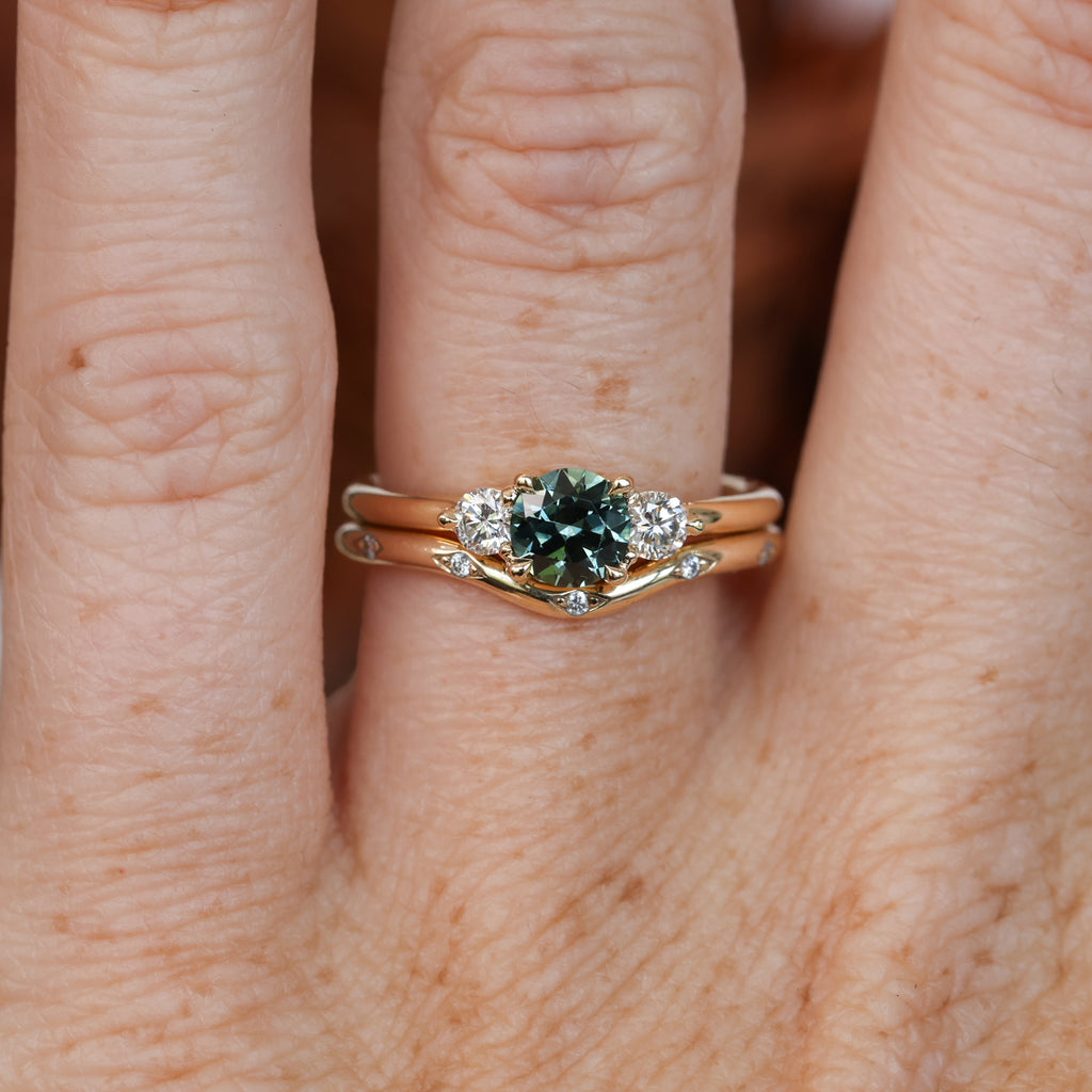 0.68ct round cut natural australian sapphire and diamond trilogy engagement ring in yellow gold with wedding band