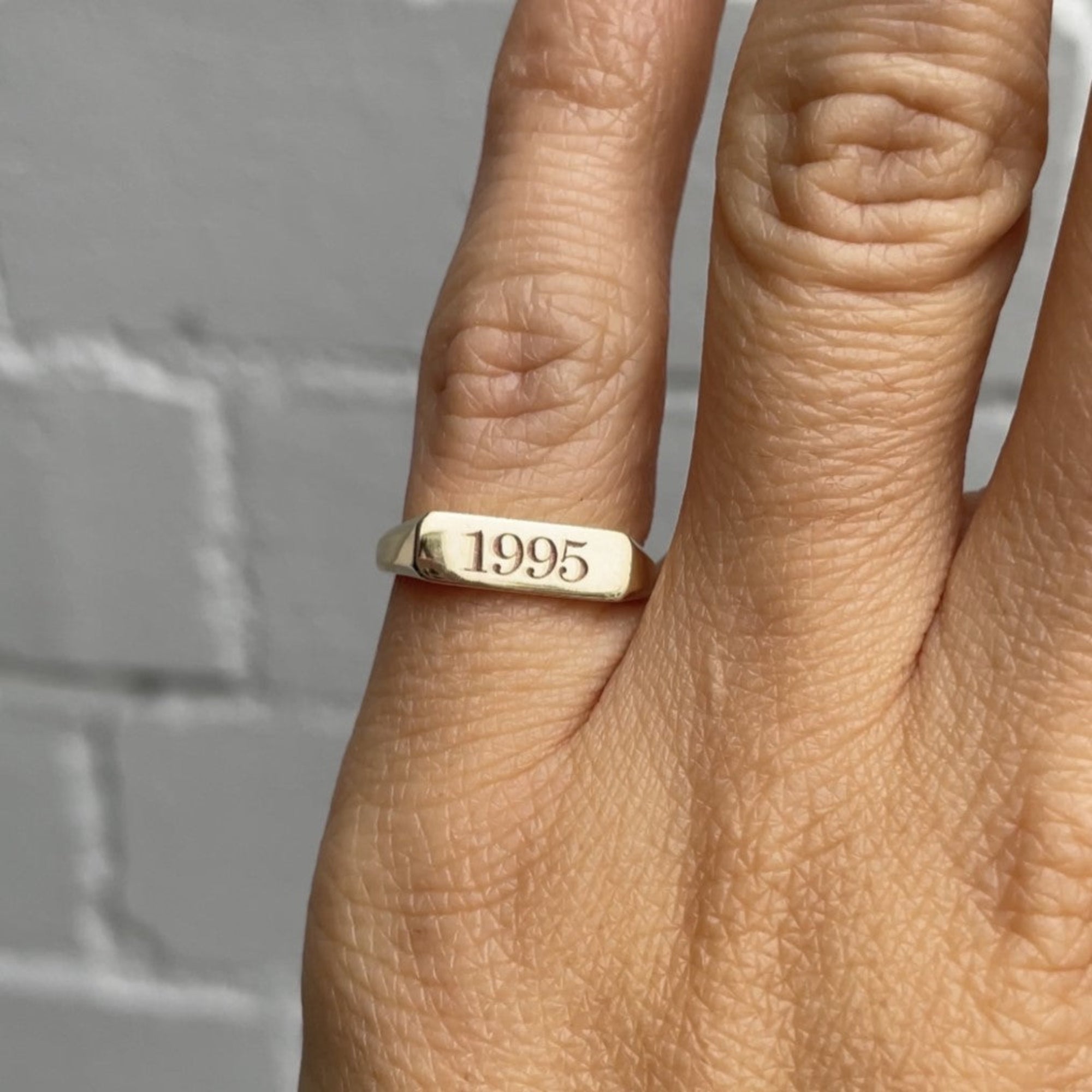 milestone bar signet ring on hand