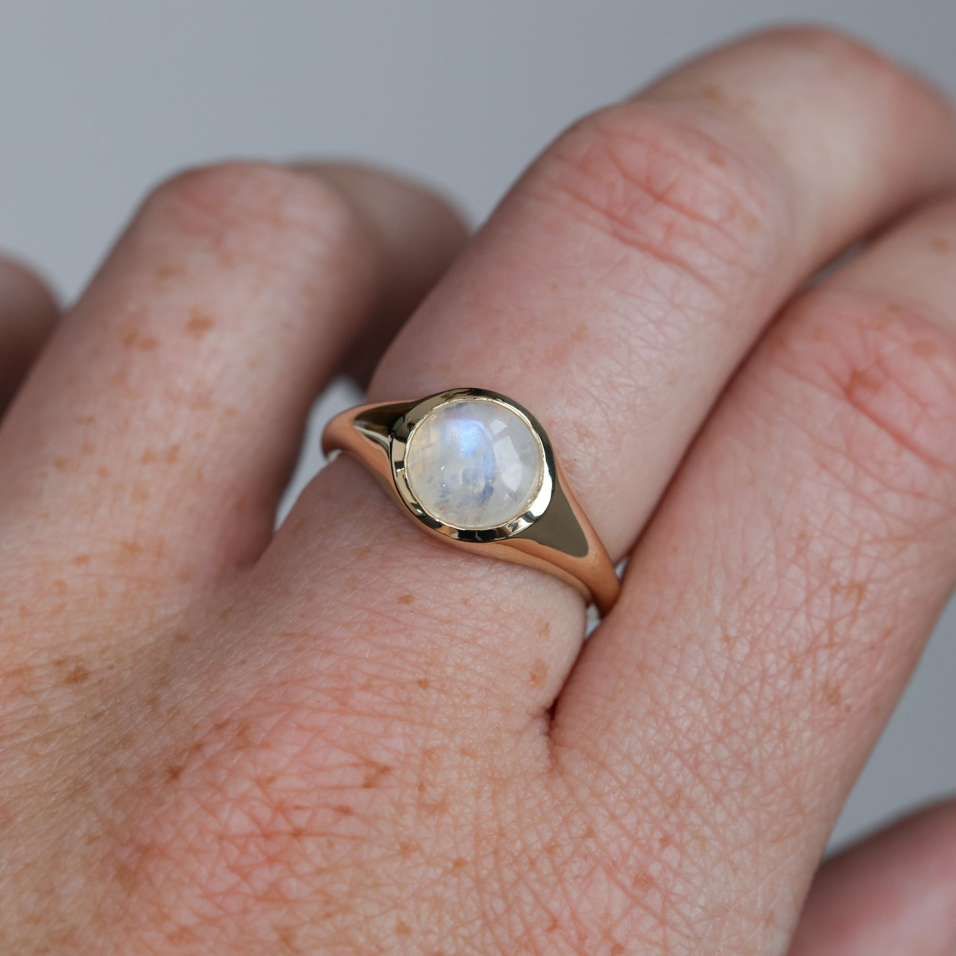 moonstone bezel cabochon ring on hand