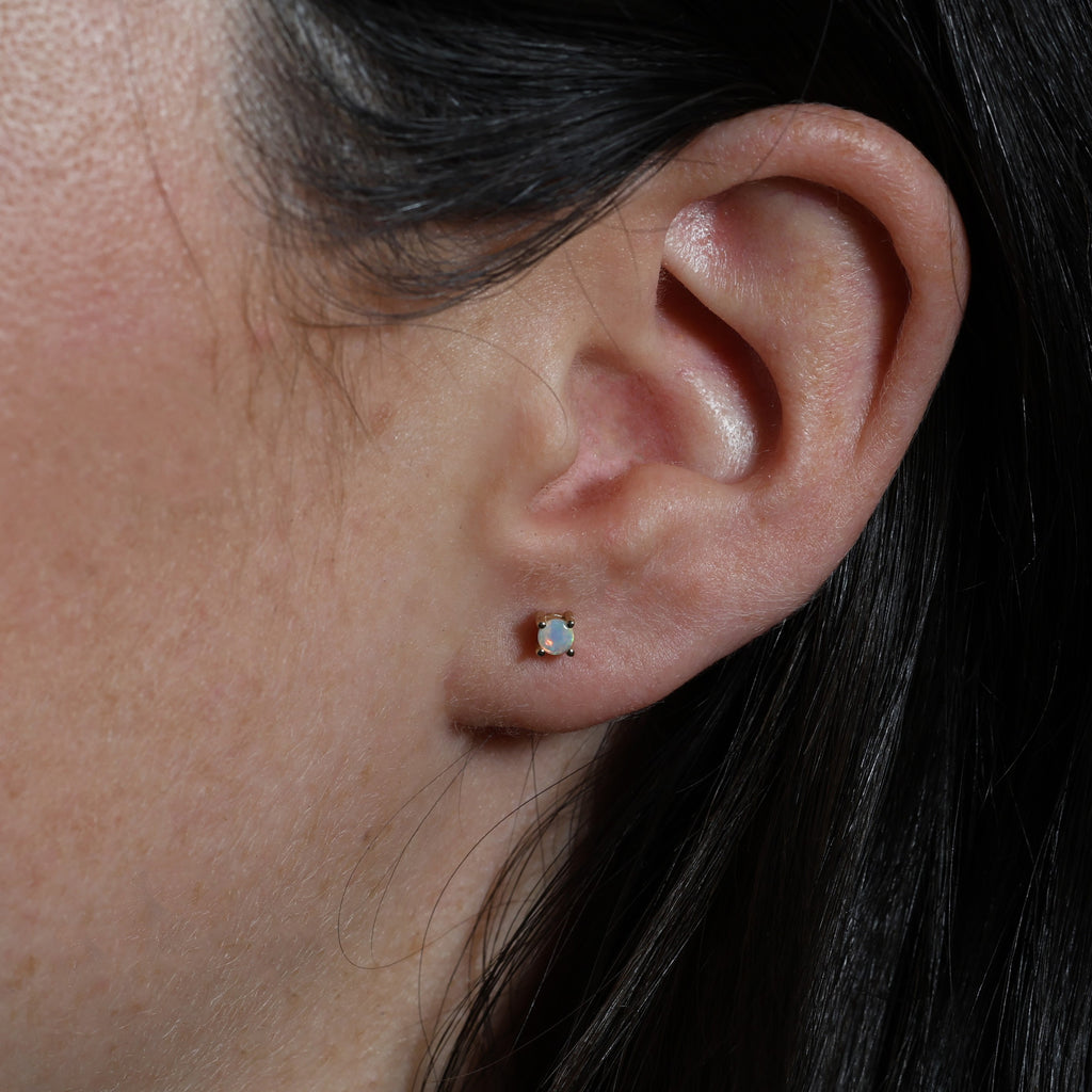 opal stud earring in ear