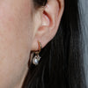 pearl and diamond earring in ear