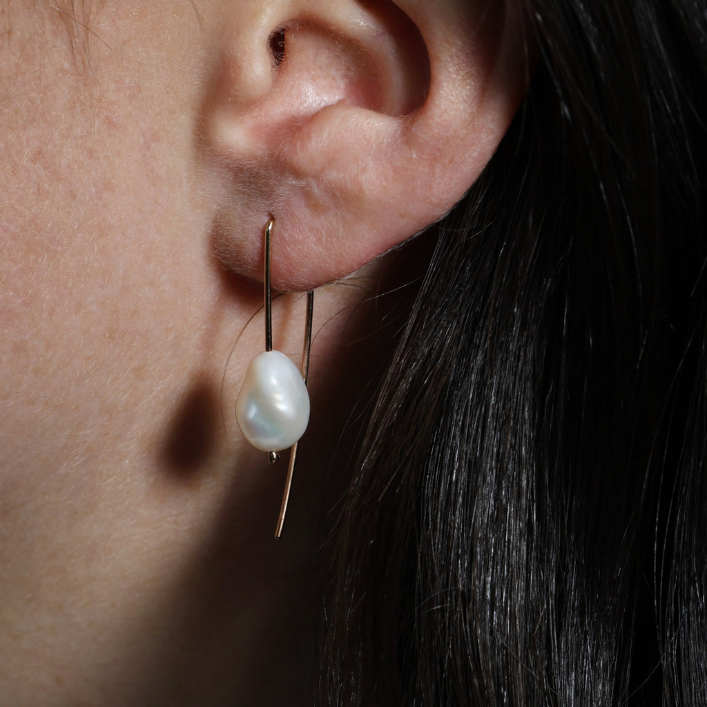 pearl trail earrings in ear