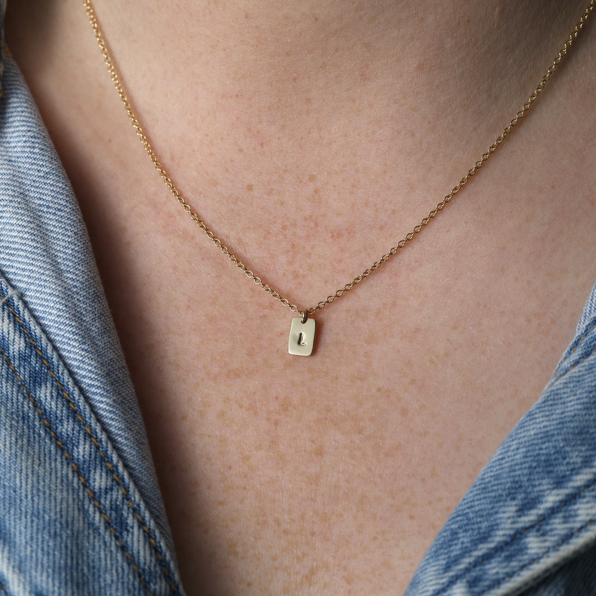 petite initial tablet necklace on neck