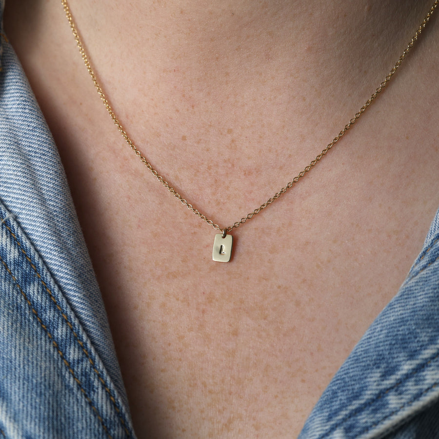 petite initial tablet necklace on neck