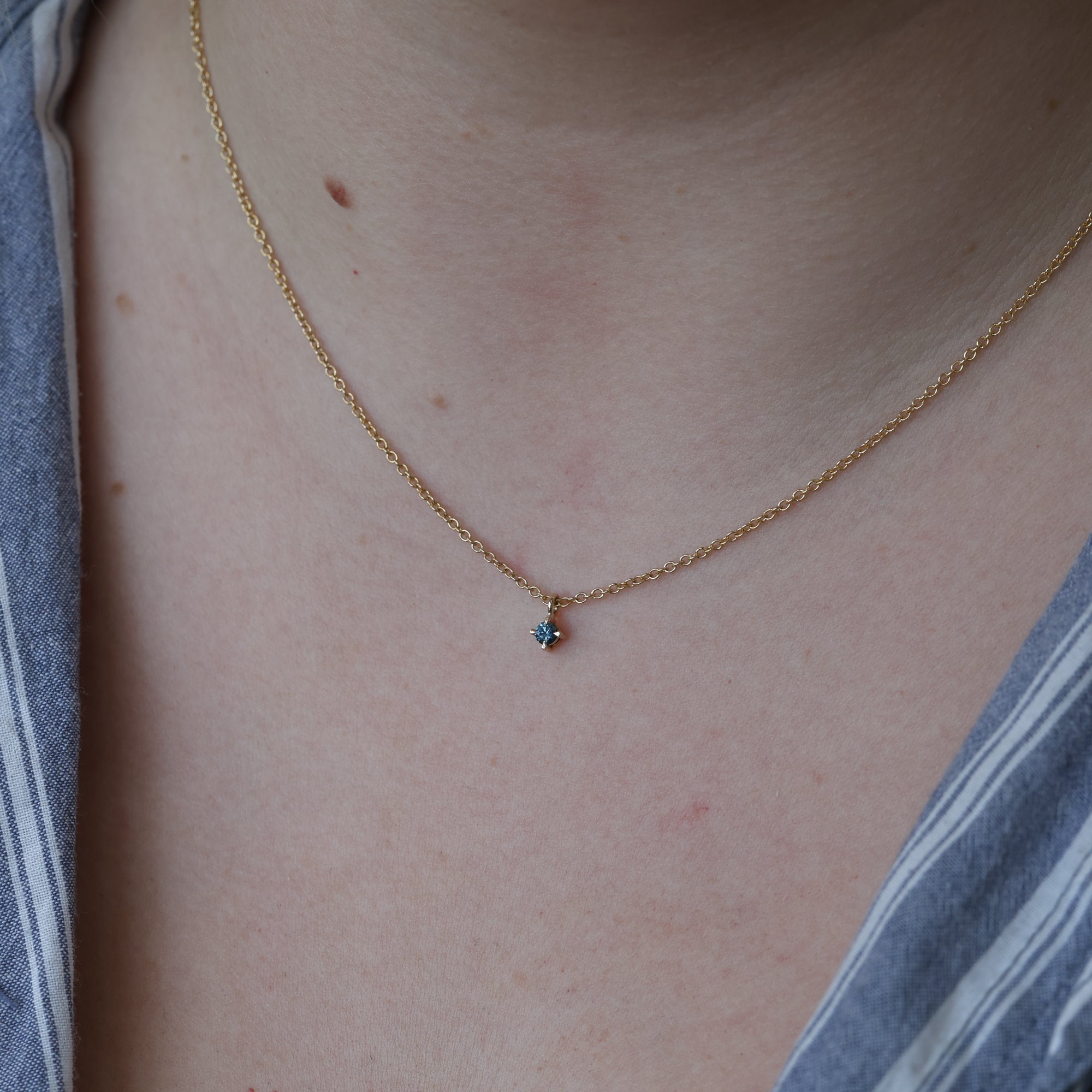 petite montana sapphire necklace yellow gold on  neck