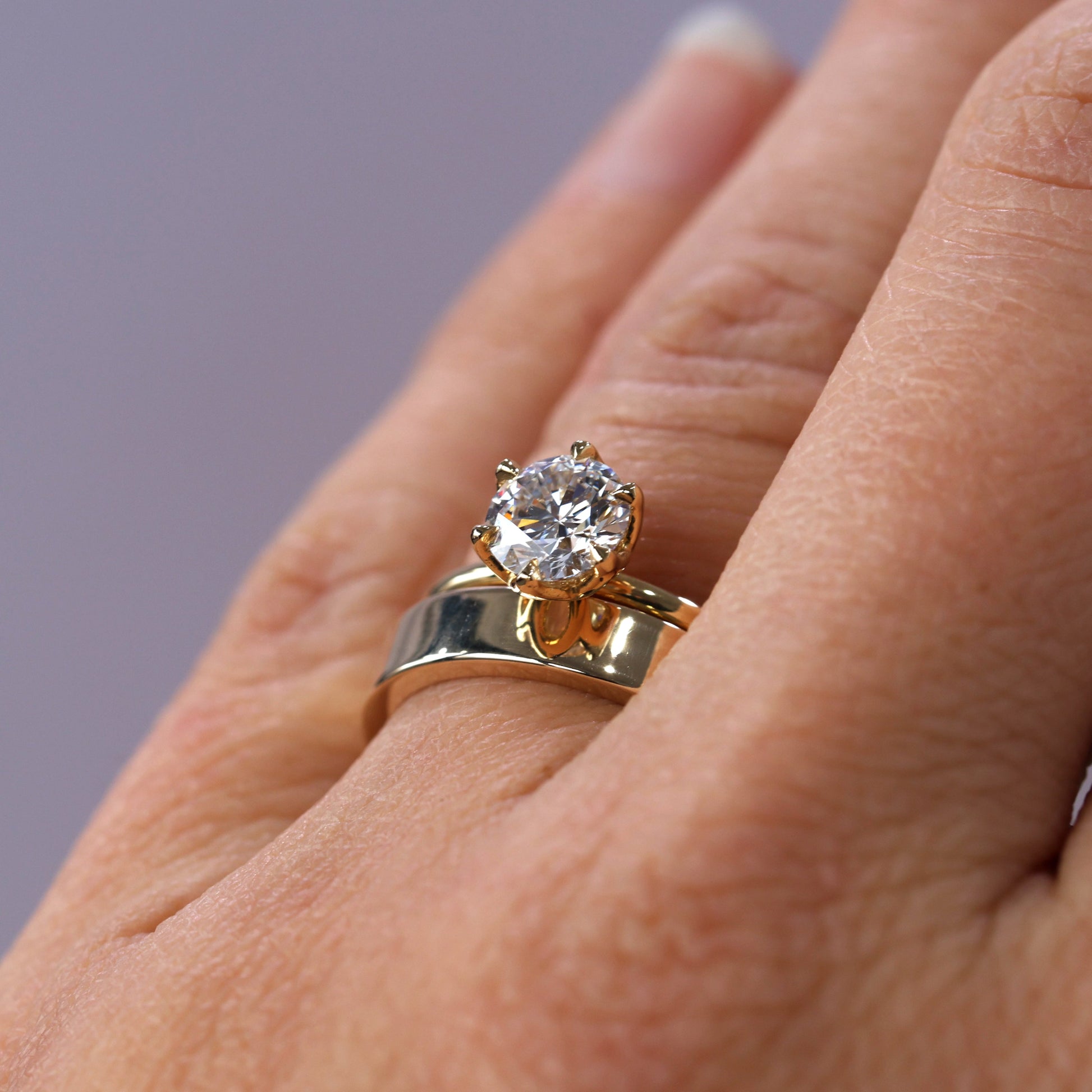 rhae 4mm gold wedding band on hand with engagement ring