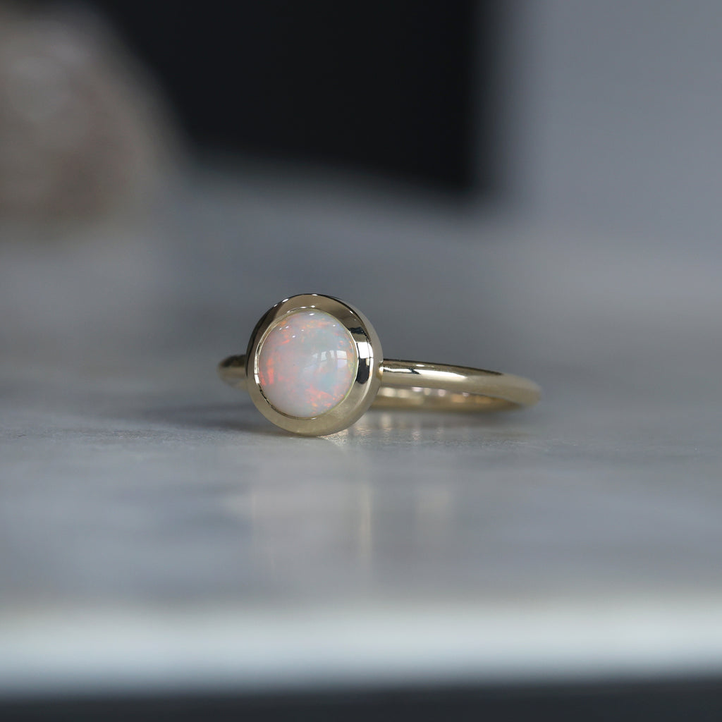 round cut bezel set Australian opal ring