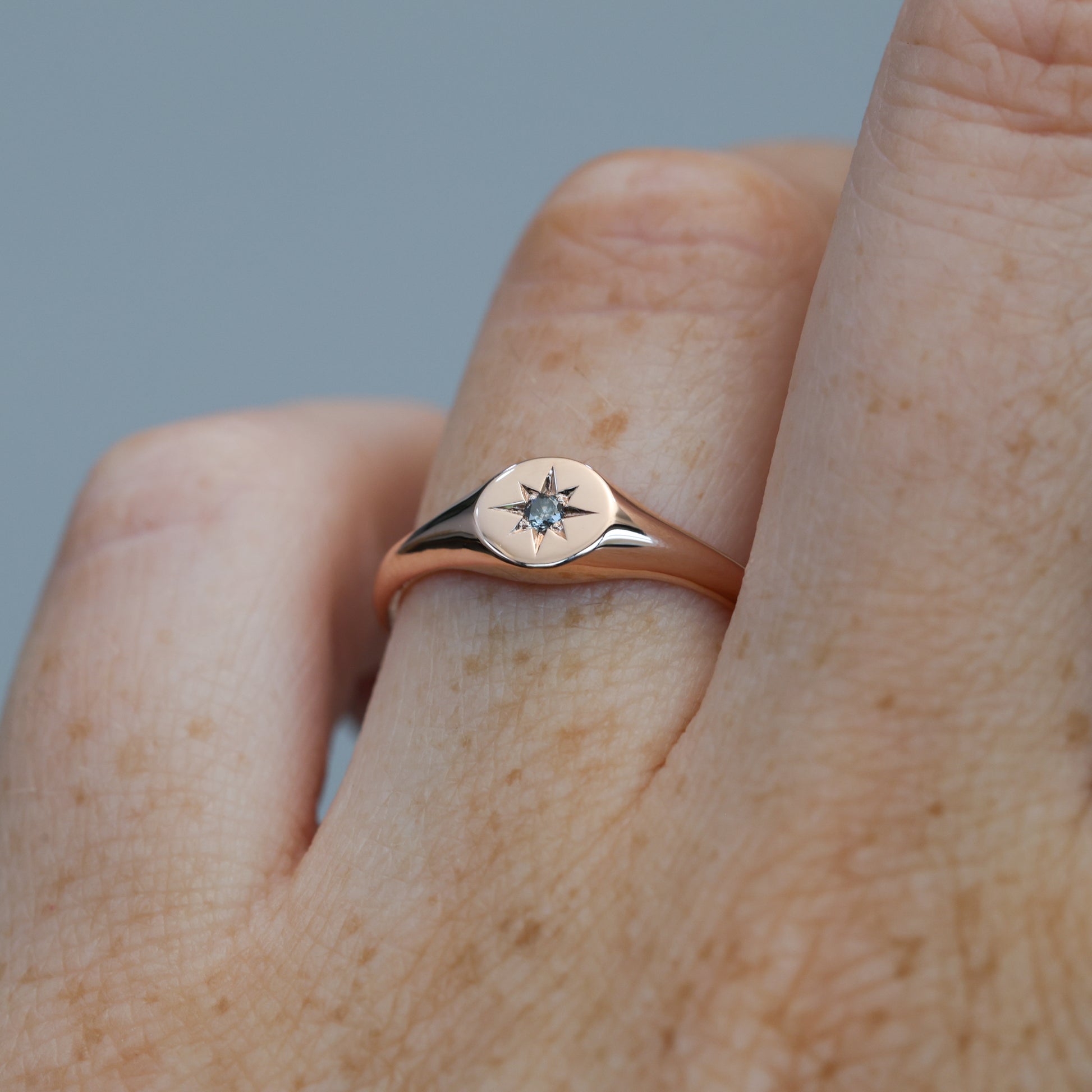 salt and pepper diamond signet ring on hand