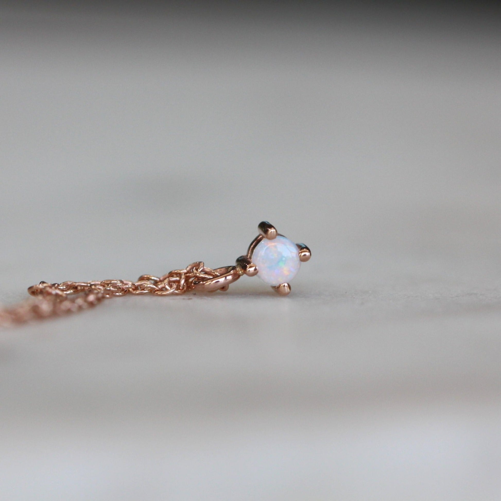 Petite opal necklace star set rose gold front view