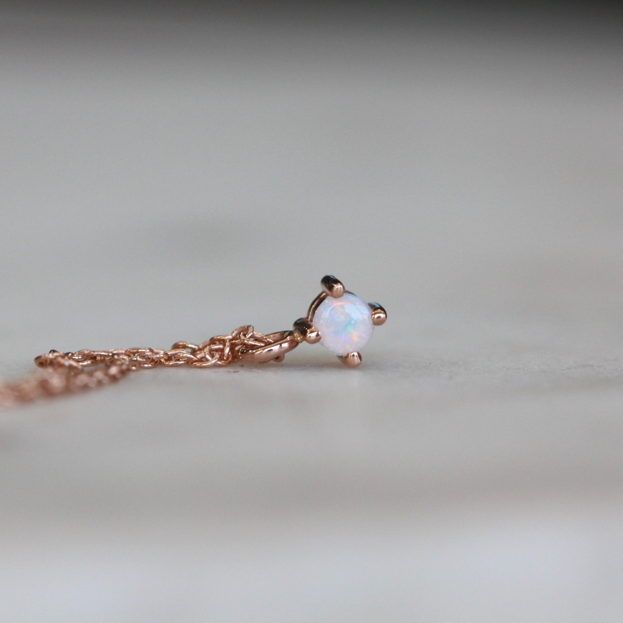 Petite opal necklace star set rose gold front view