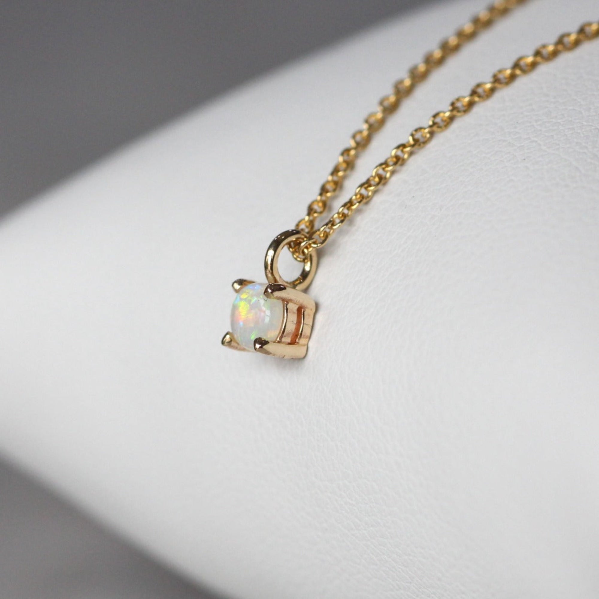 Petite opal necklace star set yellow gold