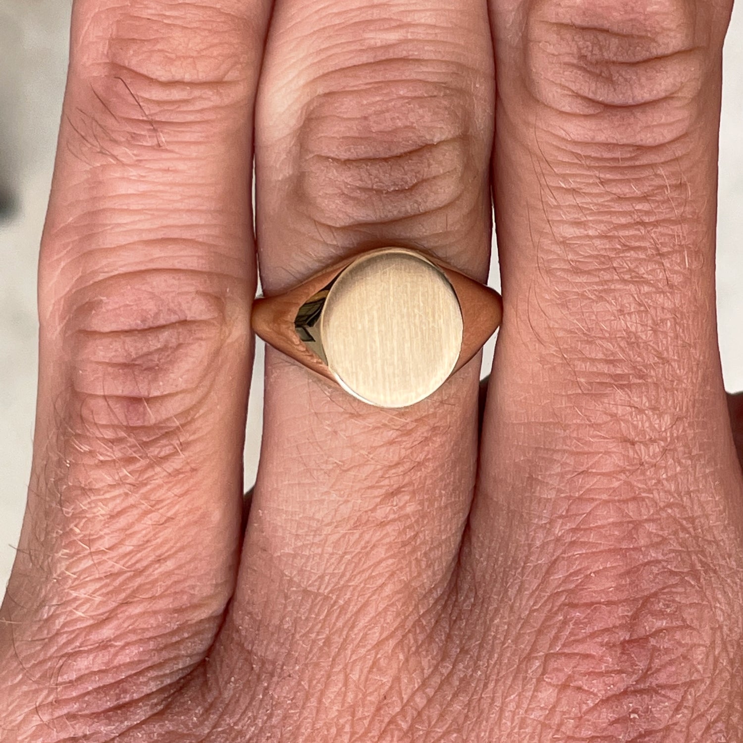 oval signet ring on hand